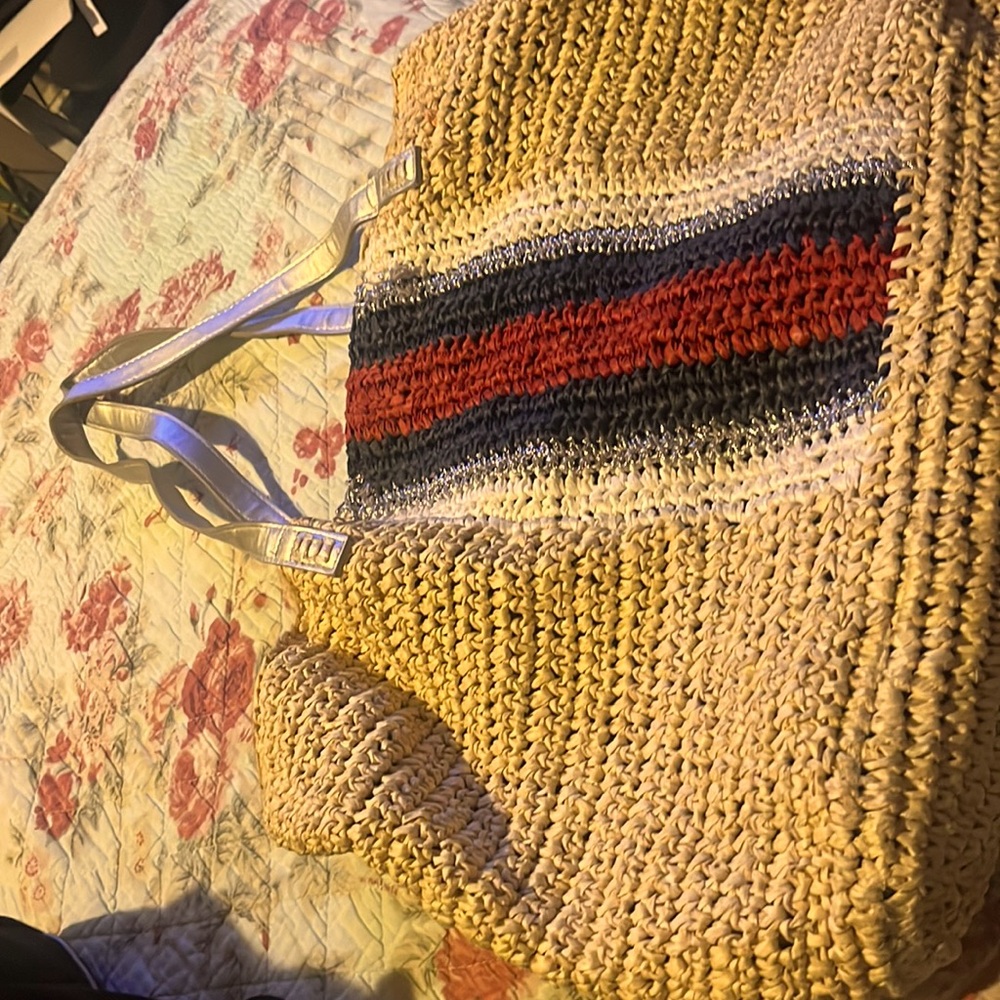 INC preowned tote. Beige, woven straw tote w/red, silver, & blue shape.